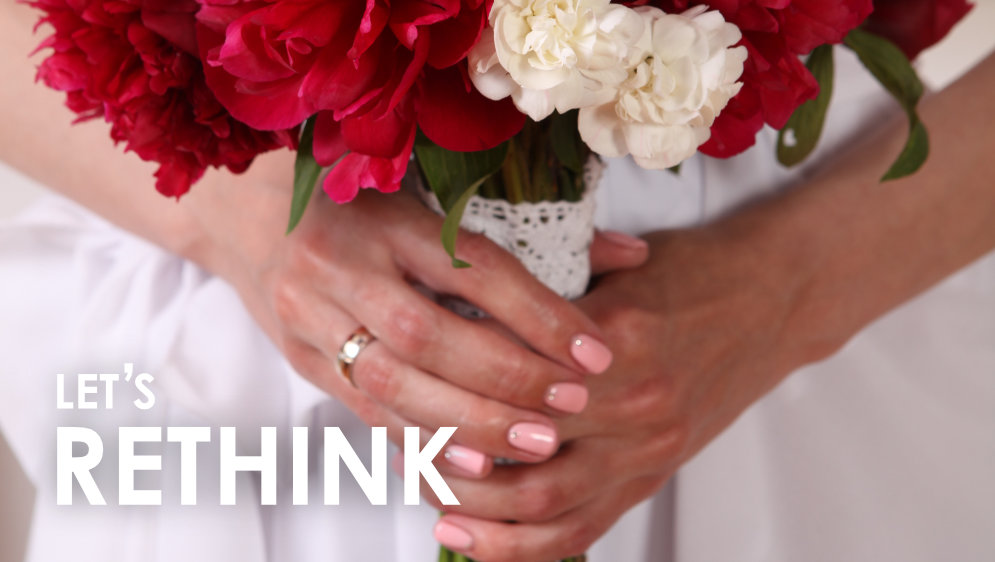 A brides hands holding a bunch of flowers