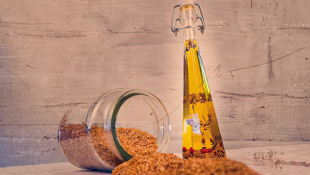 A jar of grain and a bottle of oil.